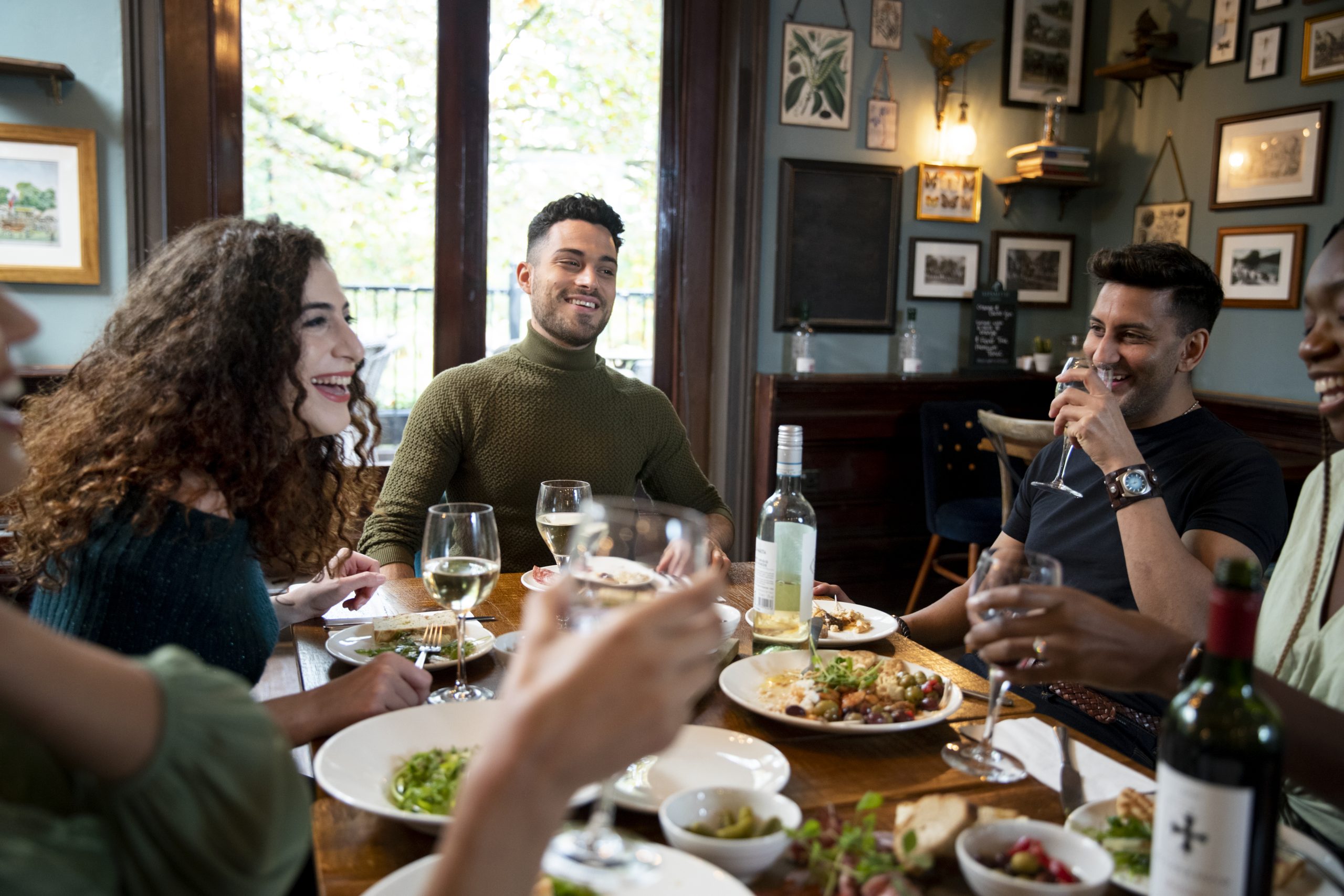 People eating and laughing together - authorFreePick